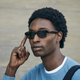 A model taps the touch interface on Amazon’s Echo Frames smart glasses.